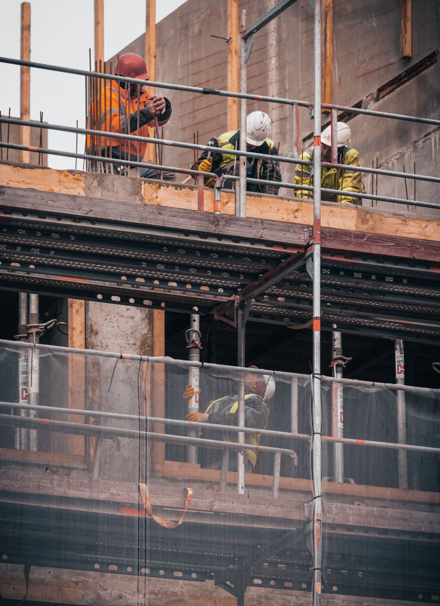 Construction crew working from scaffold platforms